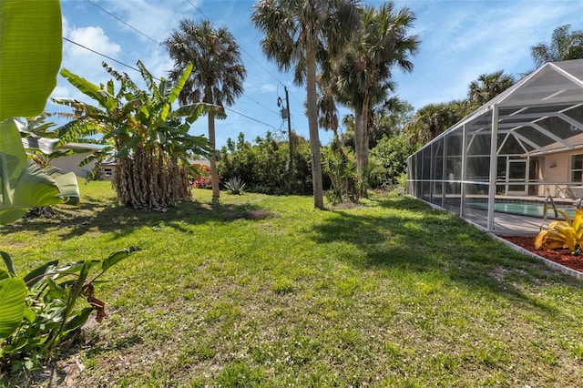 view of yard with glass enclosure