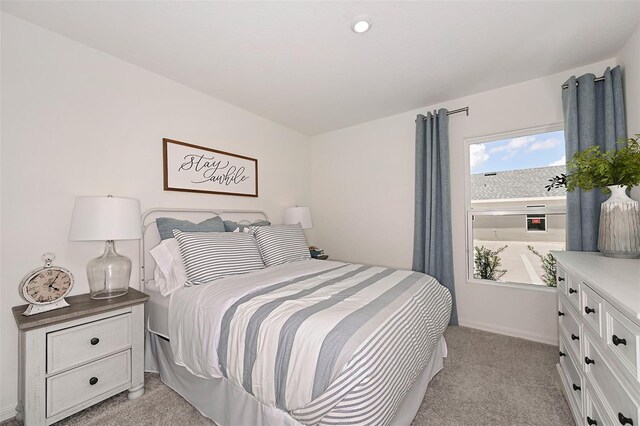 bedroom featuring light carpet