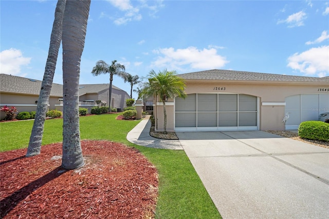 view of front of house featuring a front yard and a garage