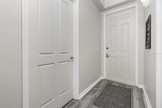 doorway with dark hardwood / wood-style floors