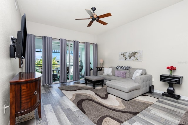 living room with ceiling fan and hardwood / wood-style flooring