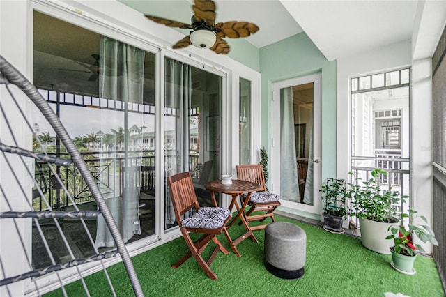 sunroom / solarium featuring ceiling fan and a healthy amount of sunlight