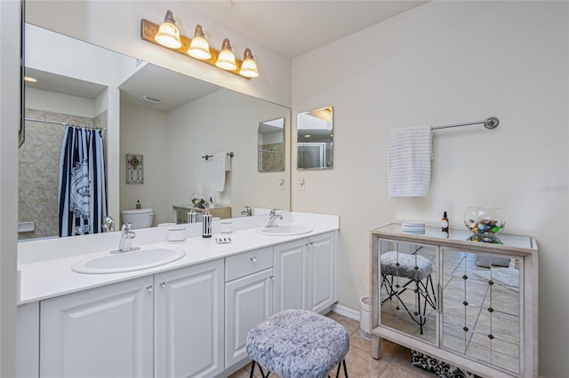 bathroom featuring tile patterned floors, vanity, a shower with shower curtain, and toilet