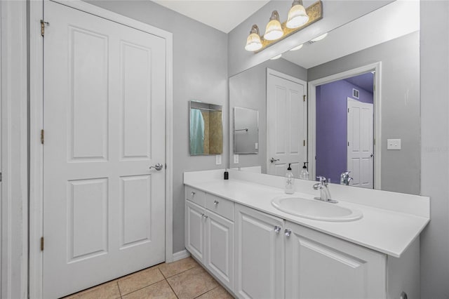 bathroom with tile patterned flooring and vanity