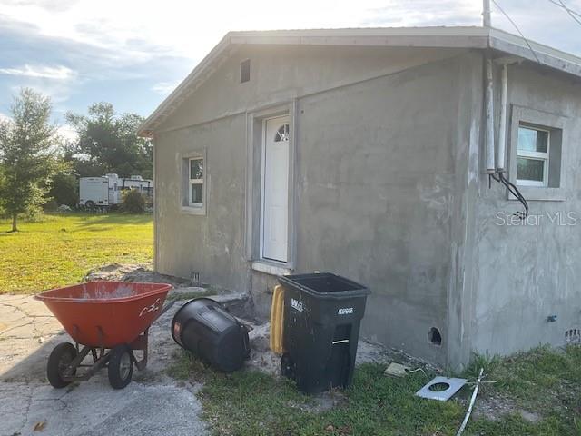 view of side of home with a yard