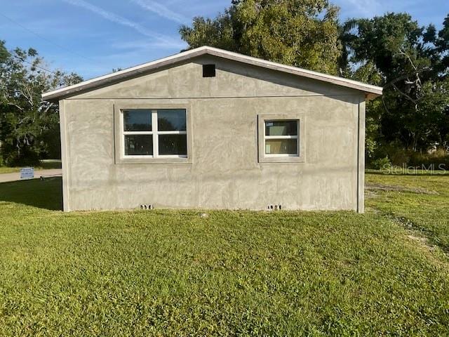 view of home's exterior with a lawn