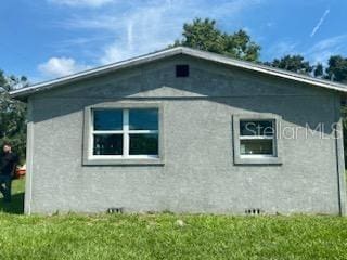 view of side of home featuring a yard