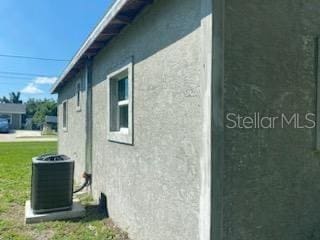 view of property exterior featuring a lawn and cooling unit