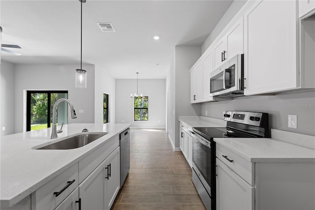 kitchen featuring white cabinets, appliances with stainless steel finishes, and sink