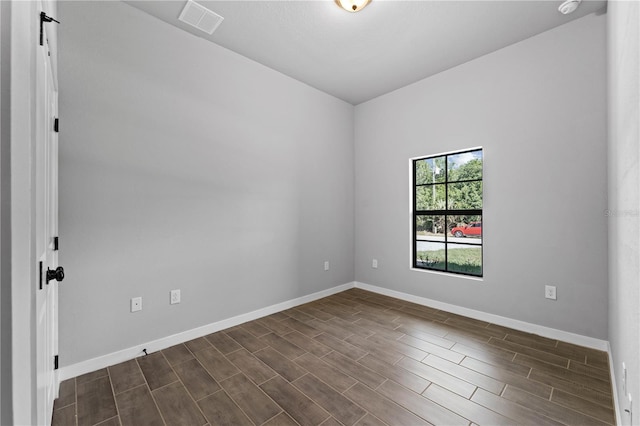 unfurnished room featuring dark wood-type flooring