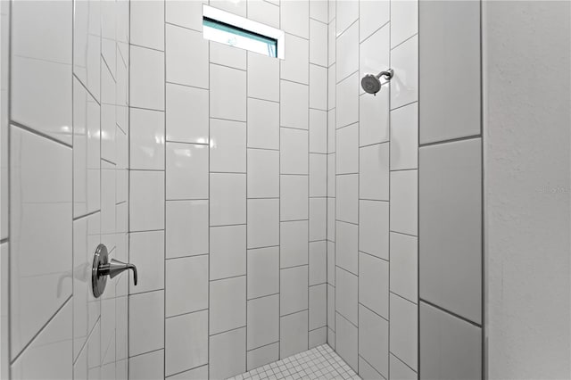 bathroom with a tile shower