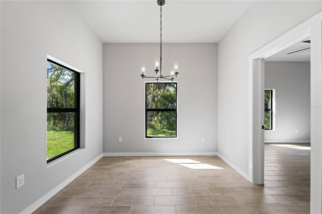 unfurnished dining area with a notable chandelier