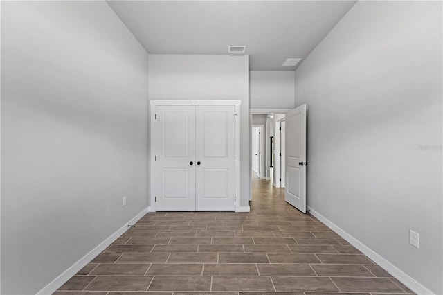 interior space with dark hardwood / wood-style floors and a closet