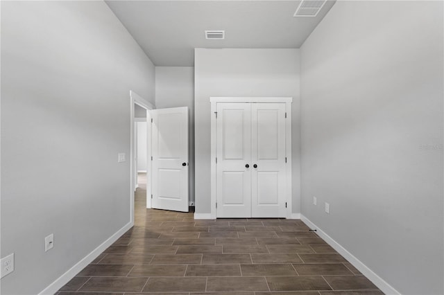 corridor featuring dark wood-type flooring