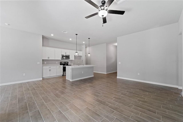 unfurnished living room featuring light hardwood / wood-style floors, sink, and ceiling fan