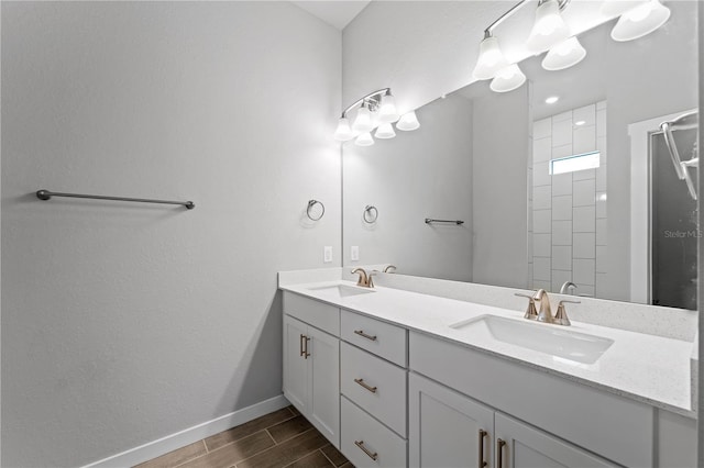 bathroom with a shower, vanity, and hardwood / wood-style flooring