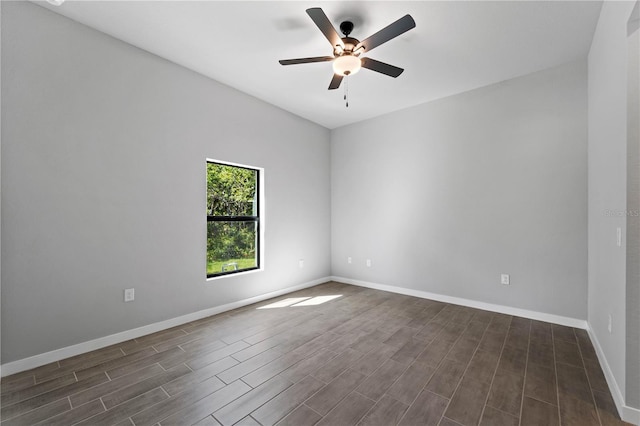 spare room with ceiling fan and dark wood-type flooring