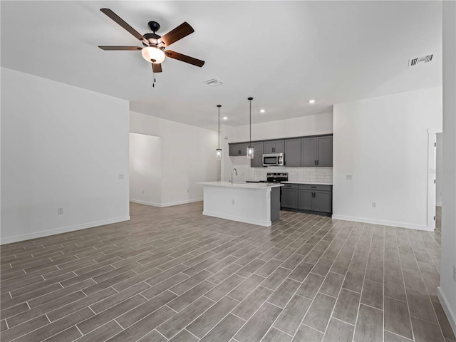 unfurnished living room with hardwood / wood-style flooring, ceiling fan, and sink