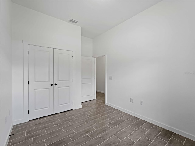 unfurnished bedroom with hardwood / wood-style floors and a closet