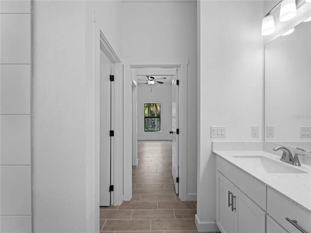 bathroom featuring hardwood / wood-style floors, ceiling fan, and vanity