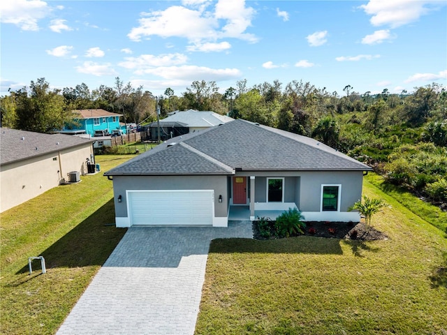 single story home featuring a garage and a front lawn