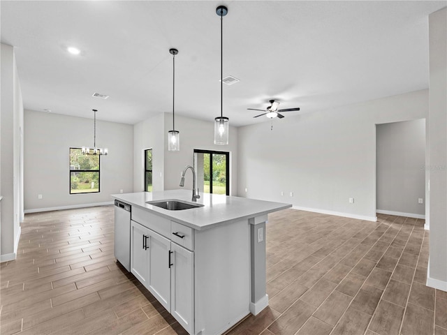 kitchen with sink, an island with sink, wood-type flooring, white cabinets, and dishwasher