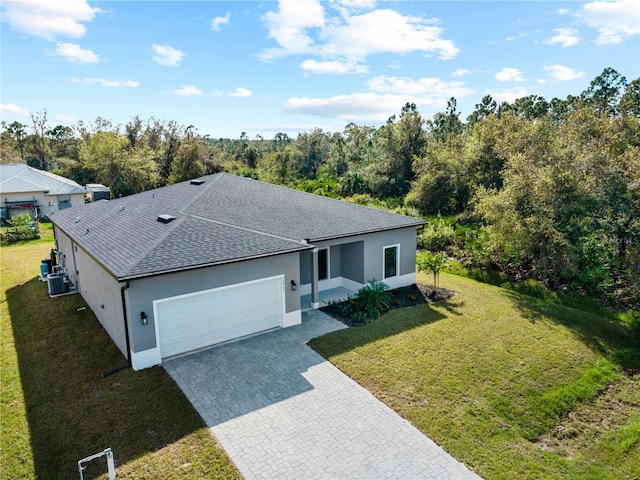 single story home featuring central air condition unit, a garage, and a front yard