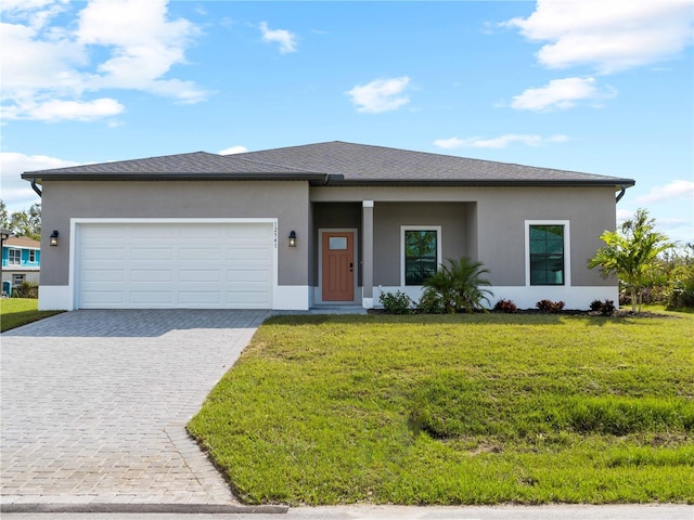 prairie-style home featuring a garage and a front lawn