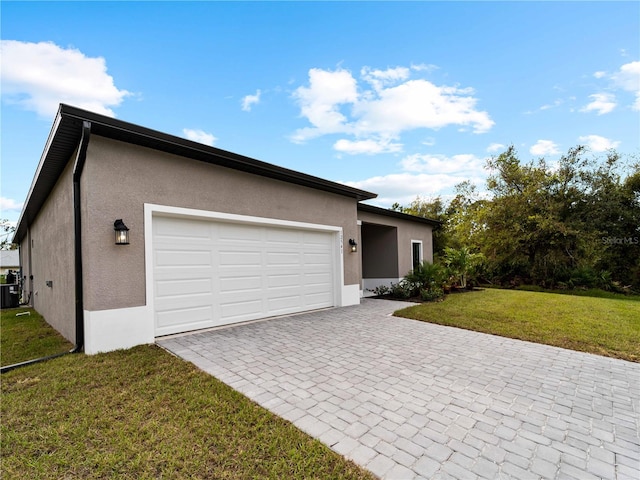 view of front of house with a front yard and a garage