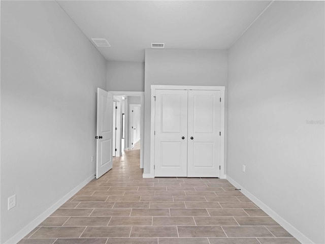 unfurnished bedroom with light hardwood / wood-style floors and a closet