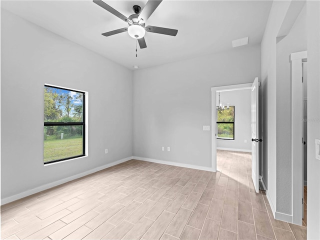 empty room featuring ceiling fan and light hardwood / wood-style floors