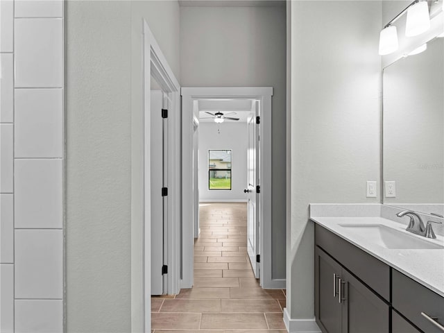 bathroom featuring vanity, ceiling fan, and wood-type flooring