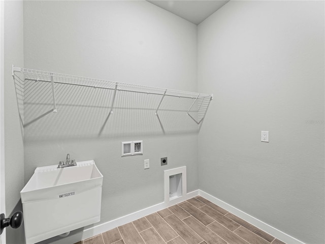 laundry room featuring hardwood / wood-style flooring, hookup for an electric dryer, sink, and washer hookup