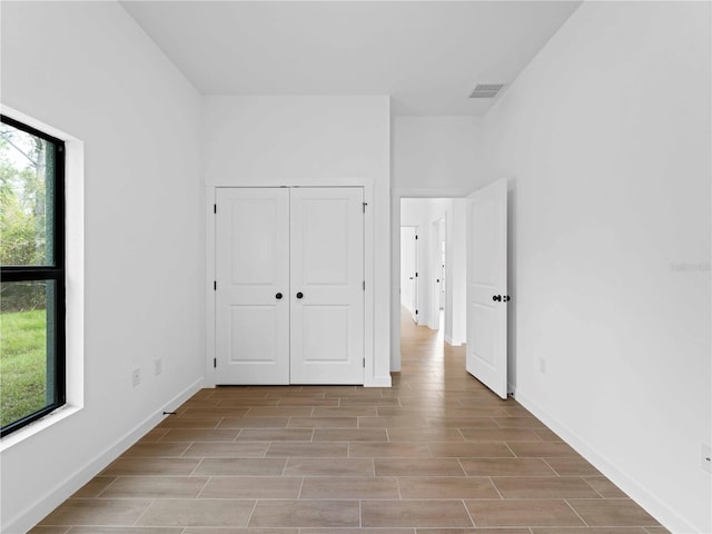 unfurnished bedroom featuring light wood-type flooring and a closet