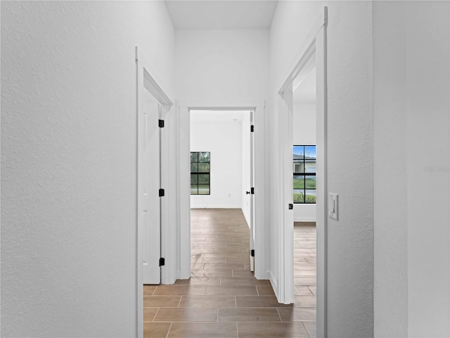 hallway with wood-type flooring