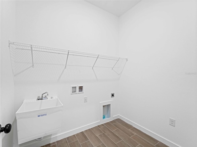 washroom with dark wood-type flooring, washer hookup, and hookup for an electric dryer