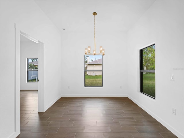 unfurnished dining area featuring dark wood-type flooring and plenty of natural light