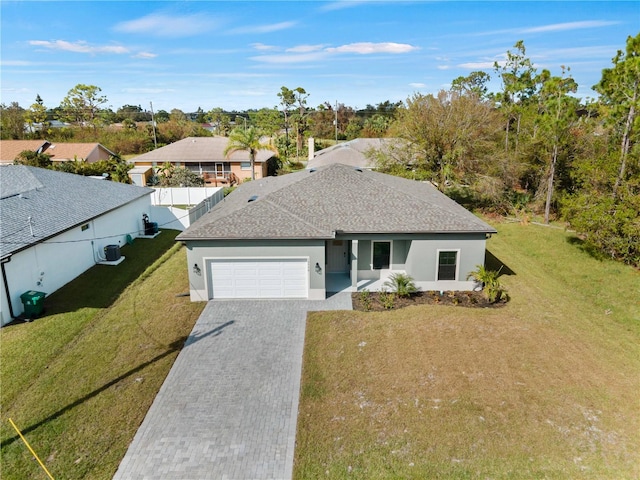 single story home with a garage and a front lawn