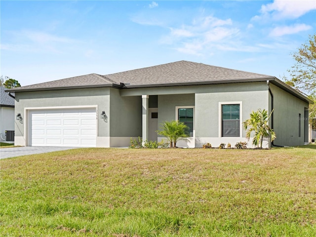 view of front of home with a front lawn, a garage, and central AC