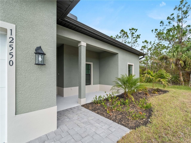 doorway to property featuring a yard