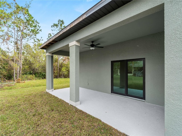 view of yard featuring ceiling fan and a patio area