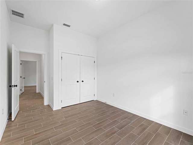 unfurnished bedroom featuring a closet and dark hardwood / wood-style flooring