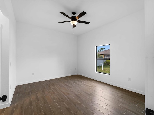 spare room featuring ceiling fan and dark hardwood / wood-style flooring