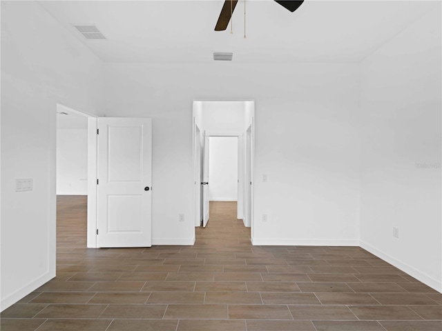 spare room featuring dark wood-type flooring and ceiling fan