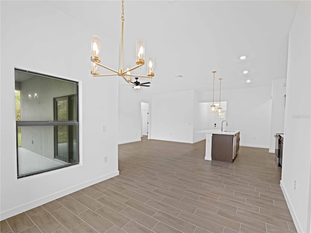 empty room with sink, ceiling fan, and light hardwood / wood-style flooring