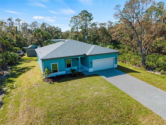 ranch-style home with a garage and a front yard