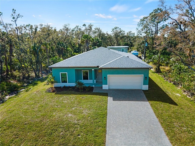 view of front of home with a garage and a front lawn