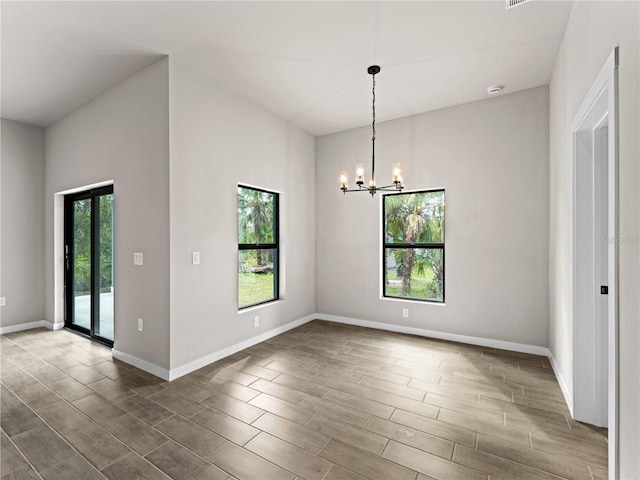 unfurnished dining area featuring an inviting chandelier, hardwood / wood-style flooring, and plenty of natural light