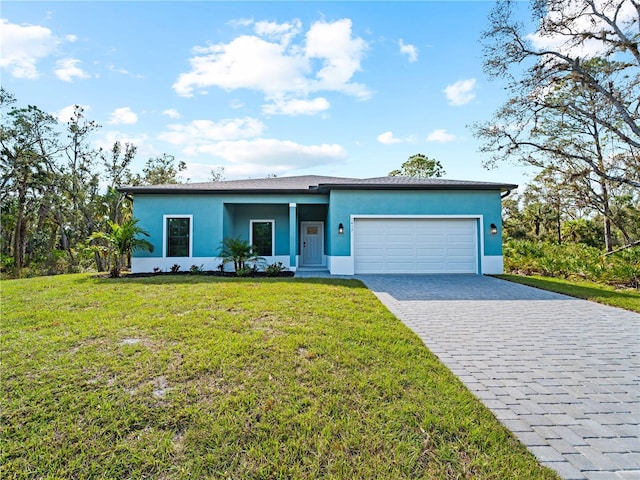 view of front of home with a garage and a front yard