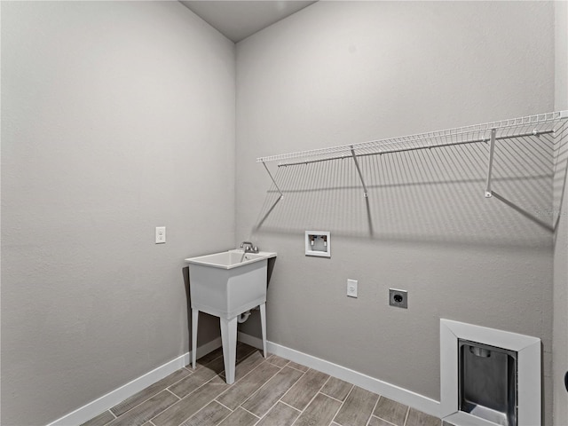 washroom featuring washer hookup, hardwood / wood-style flooring, and hookup for an electric dryer